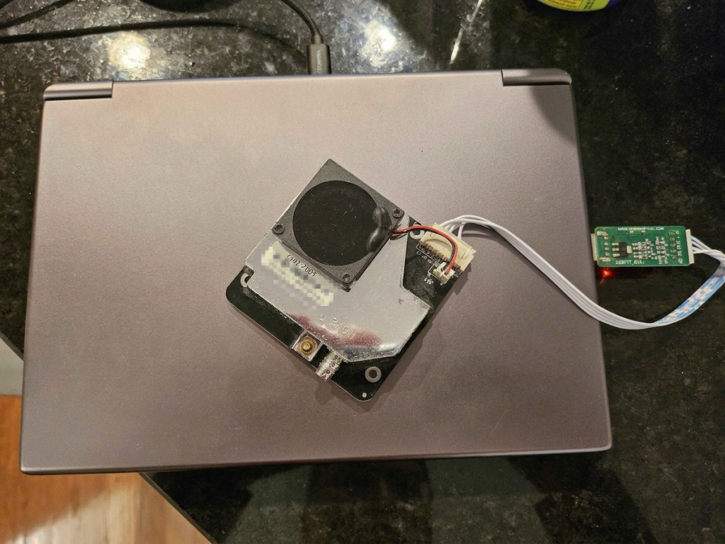 A Nova PM sensor wired to a small USB serial board sitting on top of a GPD Win Max 2 handheld PC.